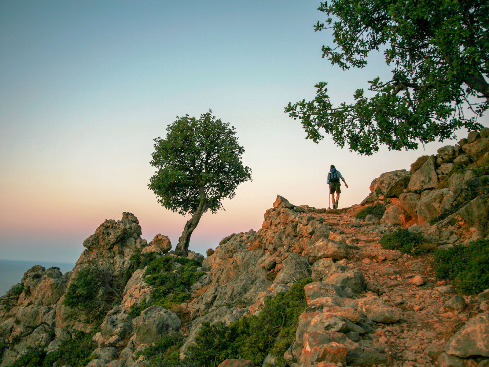 Rear view of a backpacker climbing a mountain in Crete, Greece